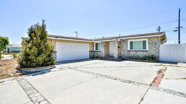 7360 Thunderbird Ln, Stanton, CA 90680 - single story home featuring concrete driveway, a garage, and stone siding