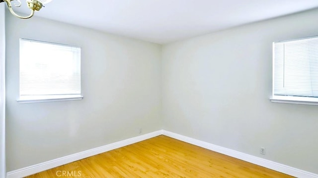 7360 Thunderbird Ln, Stanton, CA 90680 - unfurnished room with light wood finished floors and a chandelier