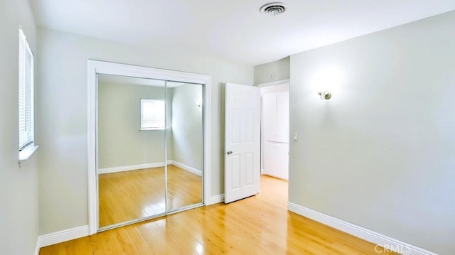 7360 Thunderbird Ln, Stanton, CA 90680 - unfurnished bedroom with light wood finished floors and a closet