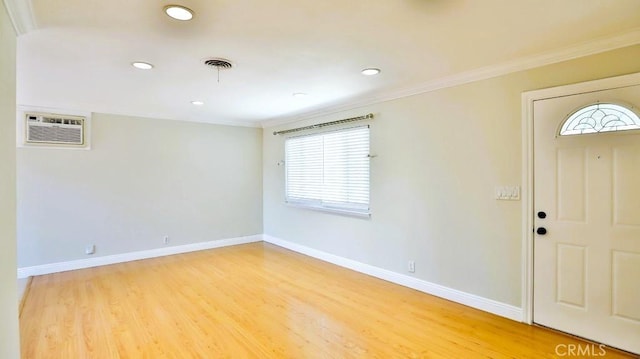 7360 Thunderbird Ln, Stanton, CA 90680 - foyer with a wall mounted air conditioner, healthy amount of natural light, light wood-style floors, crown molding, and recessed lighting