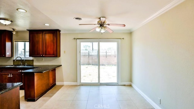 7360 Thunderbird Ln, Stanton, CA 90680 - kitchen featuring a ceiling fan, healthy amount of natural light, ornamental molding, dark stone countertops, and recessed lighting