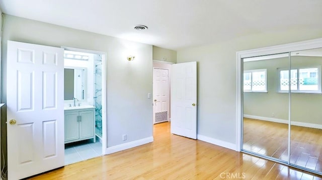 7360 Thunderbird Ln, Stanton, CA 90680 - unfurnished bedroom with light wood finished floors, a closet, and connected bathroom