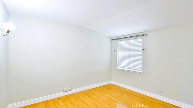 7360 Thunderbird Ln, Stanton, CA 90680 - spare room with light wood-style flooring and vaulted ceiling