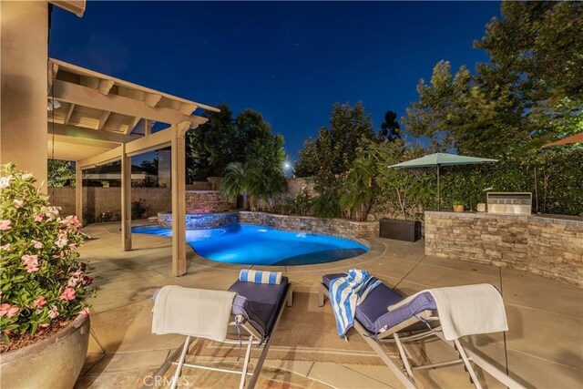 20100 Livorno Ln, Yorba Linda, CA 92886 - pool at night featuring a patio area, a fenced backyard, and exterior kitchen