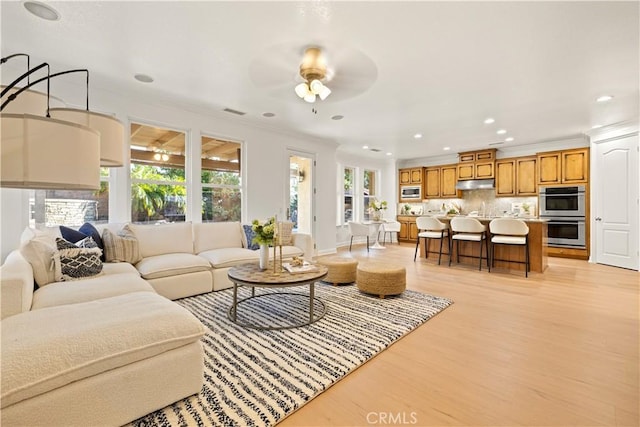 20100 Livorno Ln, Yorba Linda, CA 92886 - living area featuring light wood-style floors, a ceiling fan, recessed lighting, healthy amount of natural light, and crown molding