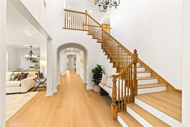 20100 Livorno Ln, Yorba Linda, CA 92886 - entryway featuring a chandelier, arched walkways, light wood finished floors, stairway, and a high ceiling