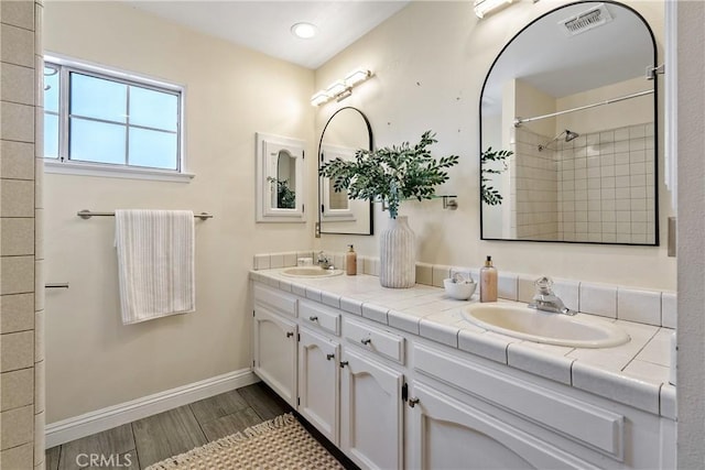 4826 Meadow Lark Ln, Paso Robles, CA 93446 - full bathroom with double vanity, wood finished floors, and a tile shower