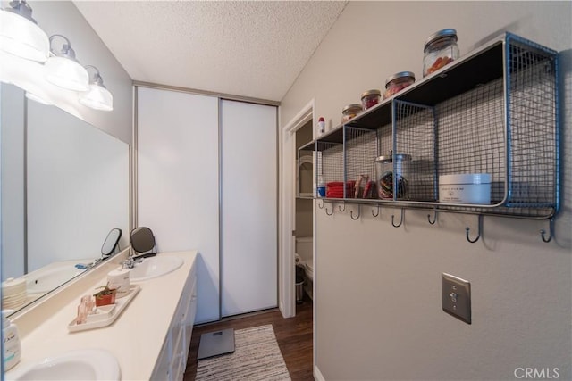 2614 S Quarry Ln Unit D, Walnut, CA 91789 - full bath featuring wood finished floors, a textured ceiling, and double vanity