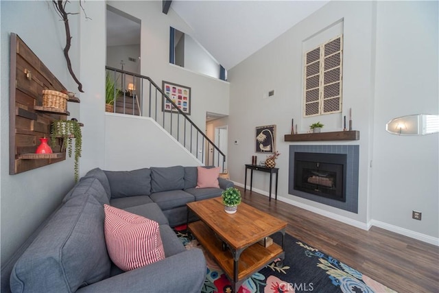 2614 S Quarry Ln Unit D, Walnut, CA 91789 - living room with wood finished floors, high vaulted ceiling, stairway, and a fireplace