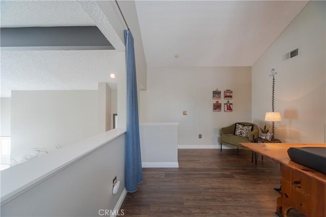 2614 S Quarry Ln Unit D, Walnut, CA 91789 - corridor featuring wood finished floors, vaulted ceiling, and a textured ceiling