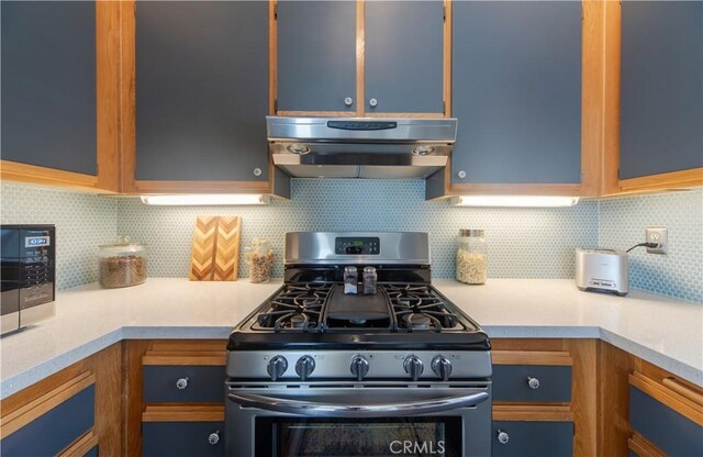 2614 S Quarry Ln Unit D, Walnut, CA 91789 - kitchen featuring stainless steel range with gas cooktop, range hood, light countertops, decorative backsplash, and blue cabinets