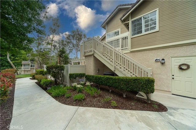 2614 S Quarry Ln Unit D, Walnut, CA 91789 - view of property exterior featuring stairway and stucco siding