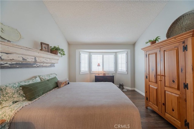 2614 S Quarry Ln Unit D, Walnut, CA 91789 - bedroom featuring vaulted ceiling, dark wood-type flooring, and a textured ceiling