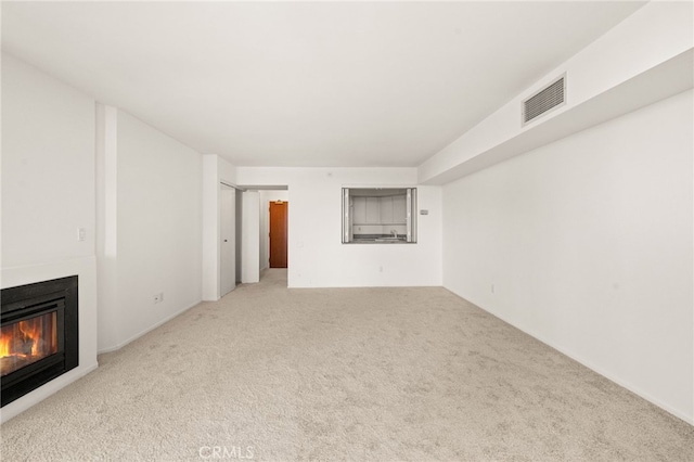 500 W Harbor Dr Unit 808, San Diego, CA 92101 - unfurnished living room featuring carpet and a glass covered fireplace