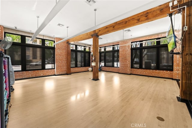 500 W Harbor Dr Unit 808, San Diego, CA 92101 - unfurnished living room with wood finished floors, brick wall, and beam ceiling