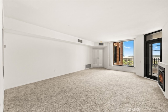 500 W Harbor Dr Unit 808, San Diego, CA 92101 - spare room with light carpet and a warm lit fireplace