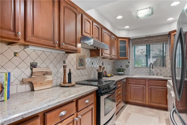 201 Calle Miramar Unit 8, Redondo Beach, CA 90277 - kitchen featuring stainless steel appliances, under cabinet range hood, brown cabinets, light stone counters, and recessed lighting