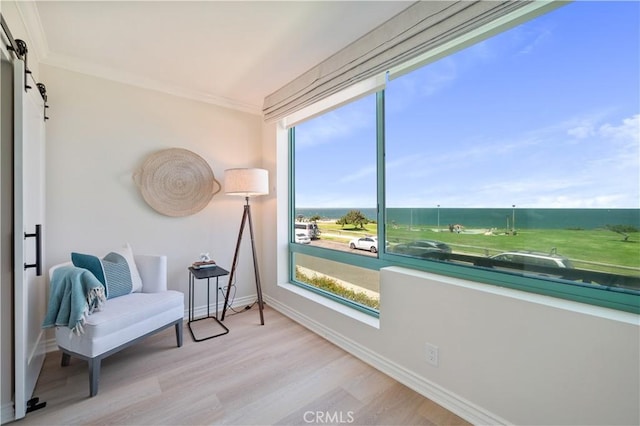 201 Calle Miramar Unit 8, Redondo Beach, CA 90277 - sitting room with a barn door, wood finished floors, a water view, and ornamental molding