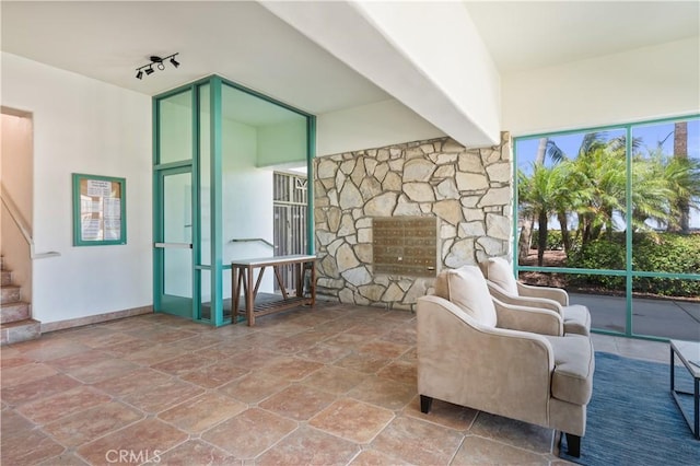 201 Calle Miramar Unit 8, Redondo Beach, CA 90277 - sitting room featuring track lighting, stone finish flooring, and stairway