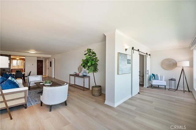 201 Calle Miramar Unit 8, Redondo Beach, CA 90277 - living room featuring a barn door, light wood-style flooring, and ornamental molding