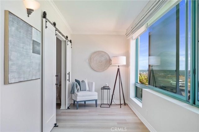 201 Calle Miramar Unit 8, Redondo Beach, CA 90277 - sitting room with a barn door, wood finished floors, and crown molding