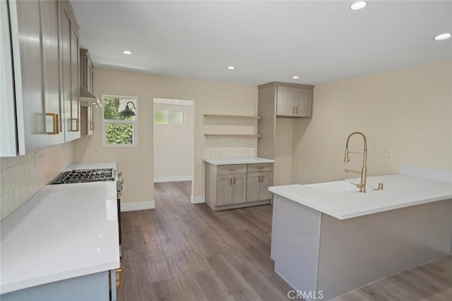3123 Hyde Park Blvd, Los Angeles, CA 90043 - kitchen with a peninsula, backsplash, wood finished floors, and recessed lighting
