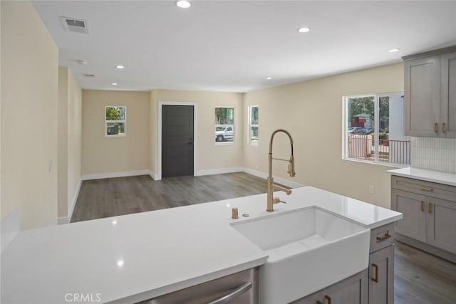 3123 Hyde Park Blvd, Los Angeles, CA 90043 - kitchen with wood finished floors, plenty of natural light, gray cabinetry, and recessed lighting