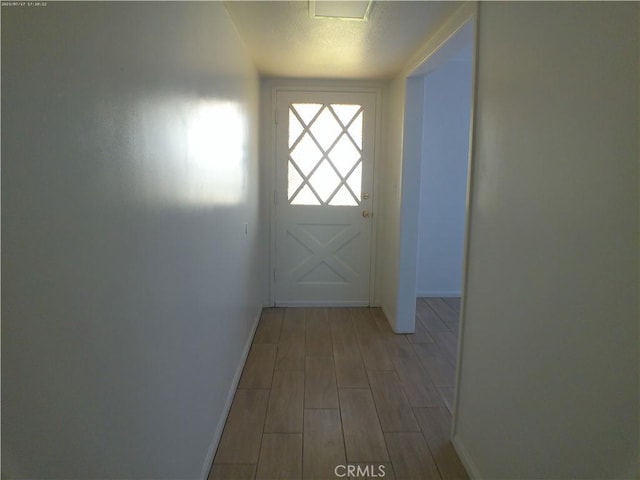 9831 Tangelo Ave, Bloomington, CA 92316 - doorway to outside featuring baseboards and light wood-type flooring