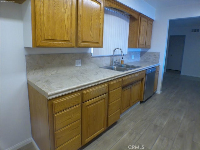 9831 Tangelo Ave, Bloomington, CA 92316 - kitchen with dishwasher, brown cabinets, light countertops, and wood finished floors