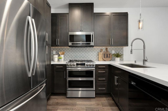 3141 Dega Pl, Carlsbad, CA 92010 - kitchen featuring appliances with stainless steel finishes, light countertops, dark wood-style floors, and tasteful backsplash