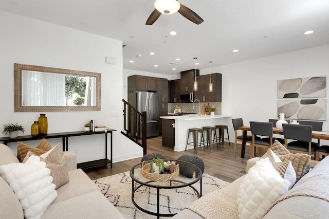 3141 Dega Pl, Carlsbad, CA 92010 - living area with ceiling fan, recessed lighting, light wood-type flooring, and stairs