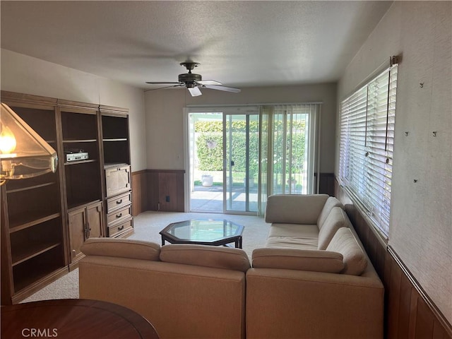 296 E 19th St, Costa Mesa, CA 92627 - living area with carpet flooring, a wainscoted wall, a ceiling fan, and a textured ceiling