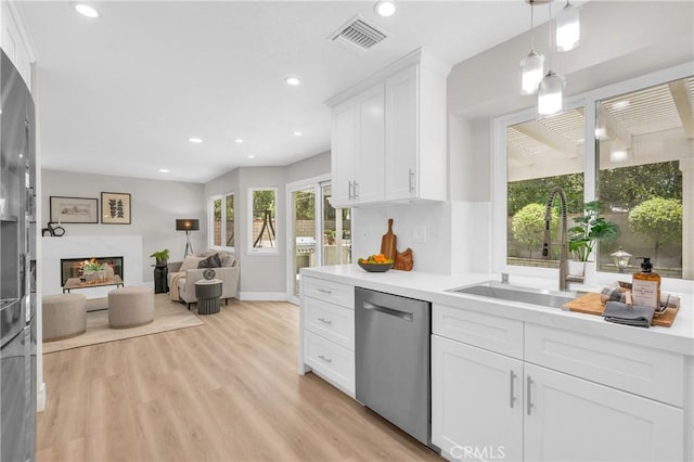 21212 Valleyview Dr, Walnut, CA 91789 - kitchen with dishwasher, white cabinets, recessed lighting, light countertops, and open floor plan