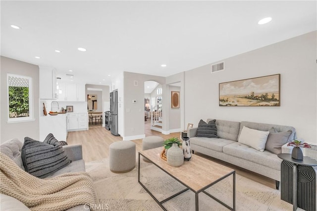 21212 Valleyview Dr, Walnut, CA 91789 - living room featuring light wood-style floors, recessed lighting, and arched walkways