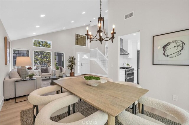 21212 Valleyview Dr, Walnut, CA 91789 - dining room with light wood finished floors, high vaulted ceiling, a chandelier, recessed lighting, and stairs