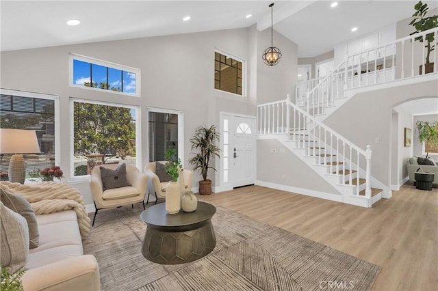 21212 Valleyview Dr, Walnut, CA 91789 - living room with stairway, light wood-style floors, high vaulted ceiling, arched walkways, and recessed lighting