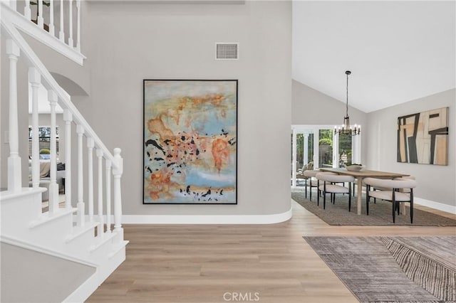 21212 Valleyview Dr, Walnut, CA 91789 - foyer entrance featuring high vaulted ceiling, stairway, light wood-type flooring, and a chandelier