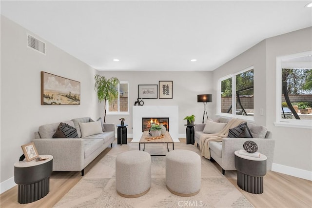 21212 Valleyview Dr, Walnut, CA 91789 - living room with wood finished floors, a warm lit fireplace, and recessed lighting