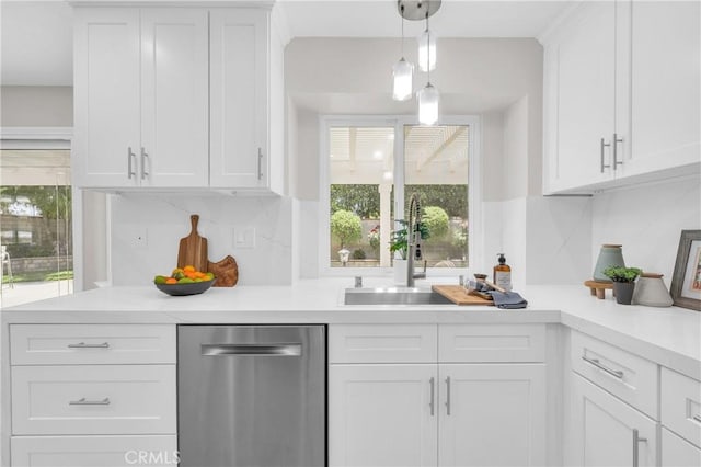 21212 Valleyview Dr, Walnut, CA 91789 - kitchen with stainless steel dishwasher, white cabinetry, light countertops, backsplash, and hanging light fixtures