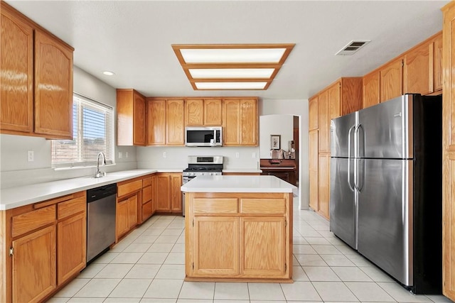 8379 Beaver Ave, Phelan, CA 92371 - kitchen featuring stainless steel appliances, light countertops, a center island, light tile patterned flooring, and recessed lighting