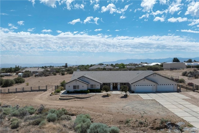 8379 Beaver Ave, Phelan, CA 92371 - ranch-style house with concrete driveway, a garage, and a mountain view
