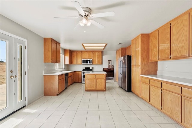8379 Beaver Ave, Phelan, CA 92371 - kitchen featuring stainless steel appliances, ceiling fan, light countertops, light tile patterned flooring, and a kitchen island