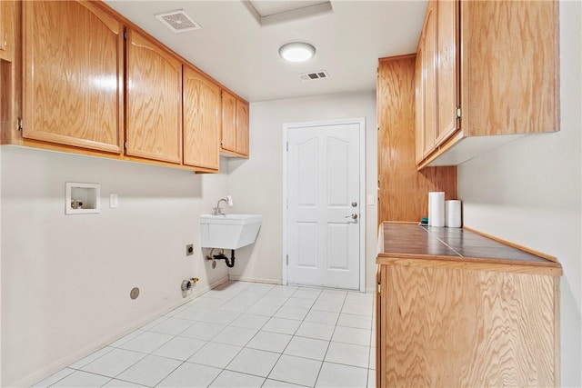 8379 Beaver Ave, Phelan, CA 92371 - laundry room featuring gas dryer hookup, hookup for an electric dryer, washer hookup, cabinet space, and light tile patterned flooring