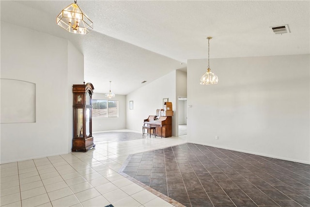 8379 Beaver Ave, Phelan, CA 92371 - unfurnished room featuring a chandelier, tile patterned floors, lofted ceiling, and a textured ceiling