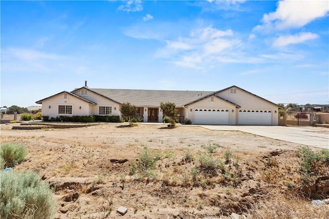 8379 Beaver Ave, Phelan, CA 92371 - ranch-style house featuring driveway, a garage, and stucco siding
