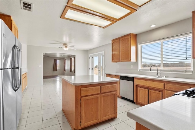 8379 Beaver Ave, Phelan, CA 92371 - kitchen featuring appliances with stainless steel finishes, healthy amount of natural light, a center island, light tile patterned flooring, and recessed lighting