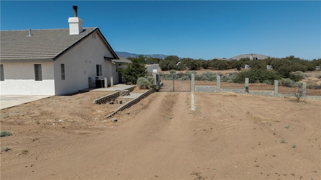 8379 Beaver Ave, Phelan, CA 92371 - view of yard with a gate and a mountain view