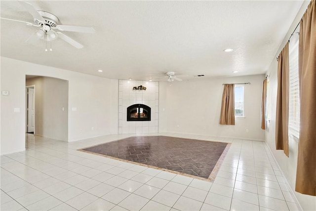 8379 Beaver Ave, Phelan, CA 92371 - unfurnished living room featuring a ceiling fan, light tile patterned floors, recessed lighting, and a tiled fireplace