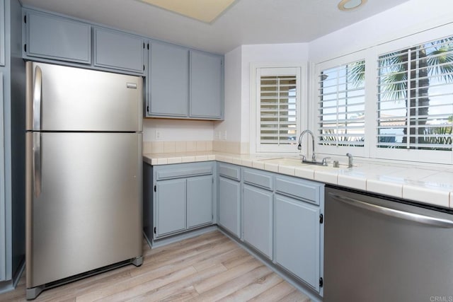 28328 Via Bandita, Menifee, CA 92585 - kitchen featuring appliances with stainless steel finishes, light wood-type flooring, and light countertops
