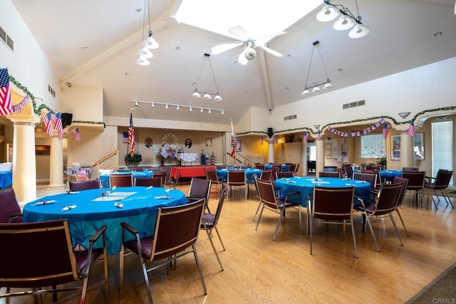 28328 Via Bandita, Menifee, CA 92585 - dining space featuring wood finished floors, ceiling fan, high vaulted ceiling, rail lighting, and ornate columns